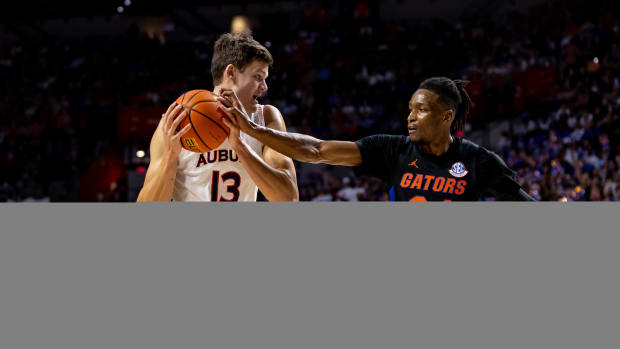 Feb 19, 2022; Gainesville, Florida, USA; Florida Gators guard Phlandrous Fleming Jr. (24) plays defense on Auburn Tigers forward Walker Kessler (13) during the first half at Billy Donovan Court at Exactech Arena. Mandatory Credit: Matt Pendleton-USA TODAY Sports